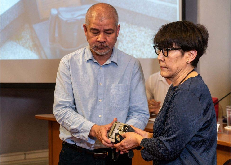 Noriko, Nagai's sister, receives the camera at the event in Bangkok