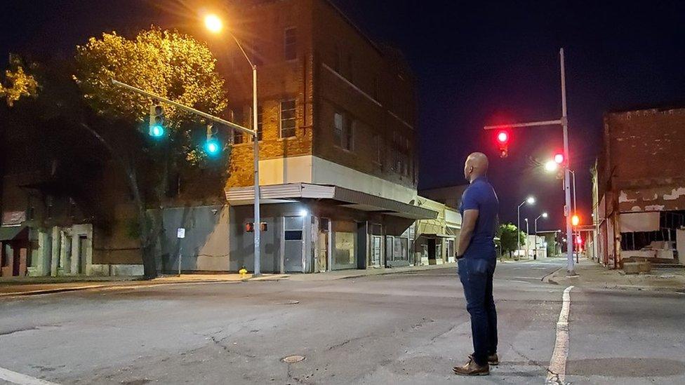 Brian Rice looking at empty buildings