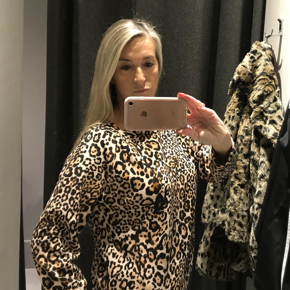 Tracy takes a selfie in leopard print