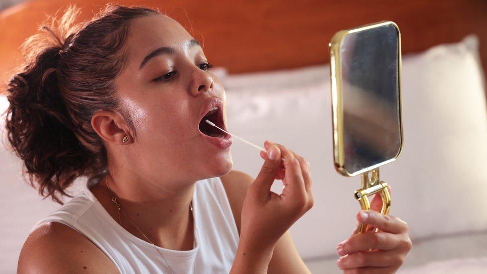 A girl using a lateral flow test