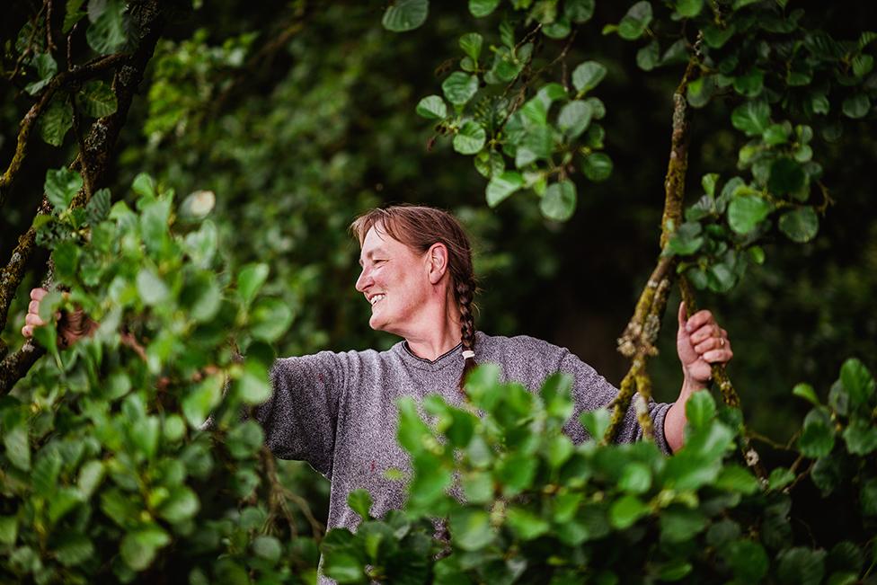 Farmer Fransje stands amongst greenery