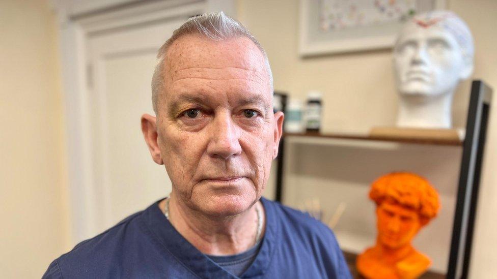 Consultant Psychiatrist, Professor Alex O'Neill-Kerr in his treatment room