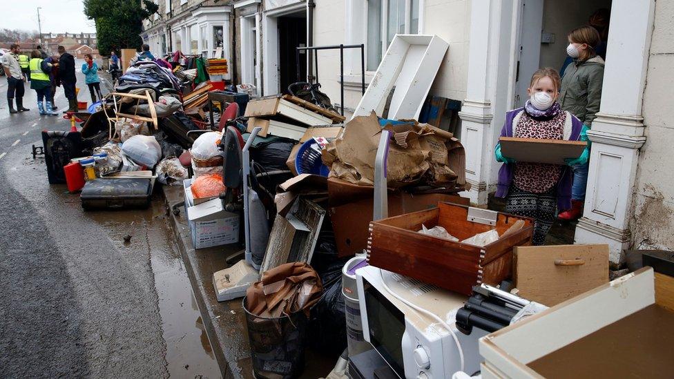 Residents and shop owners clearing their belongings onto the streets of Tadcaster in Yorkshire