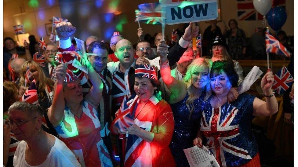 Brexit supporters wave Union flags as the time passes 11 O"Clock at a Brexit Celebration party at Woolston Social Club in Warrington, north west England