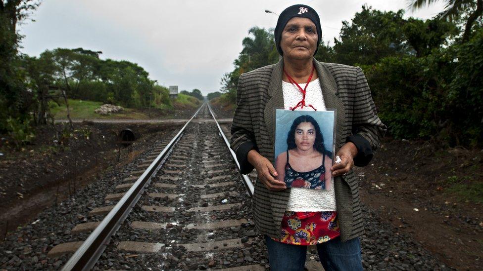 Pilar Escobar Medina holds up a photograph of her daughter Olga, who she last saw in 2009