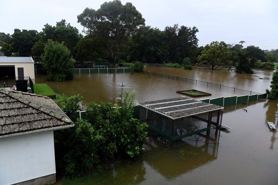 Floodwater completely submerges the backyards of properties on Ladbury Ave, in Penrith, New South Wales, Australia, 21 March 2021.