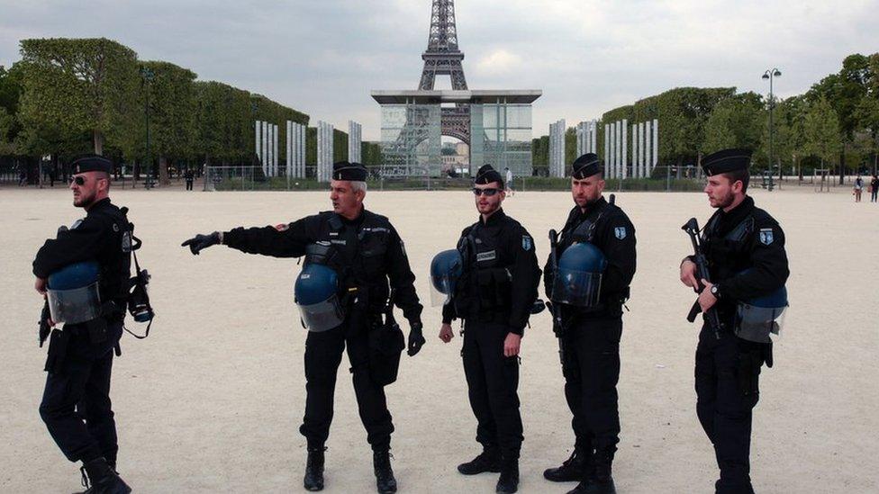 French policemen stand in front of the Eiffel tower in Paris on 22 April, 2017.