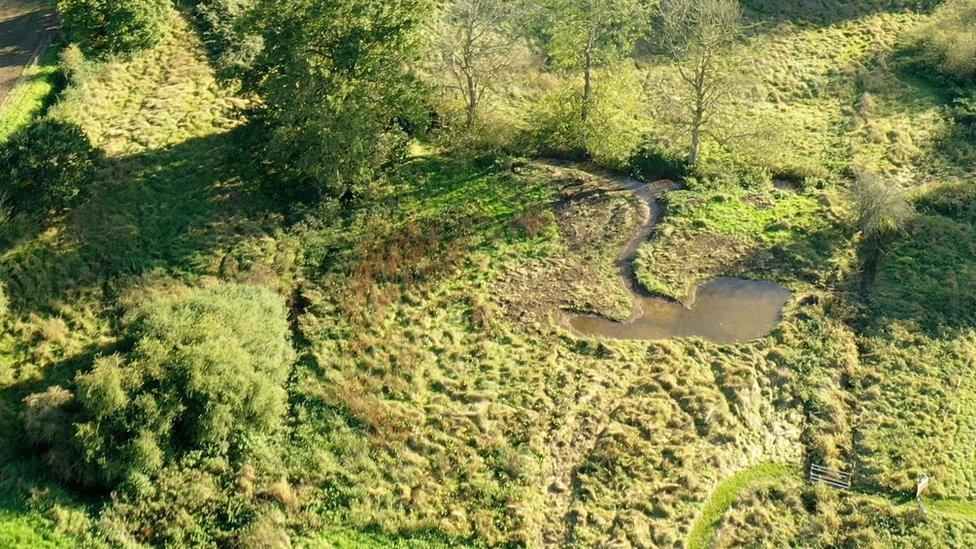 A shallow pond holding floodwater