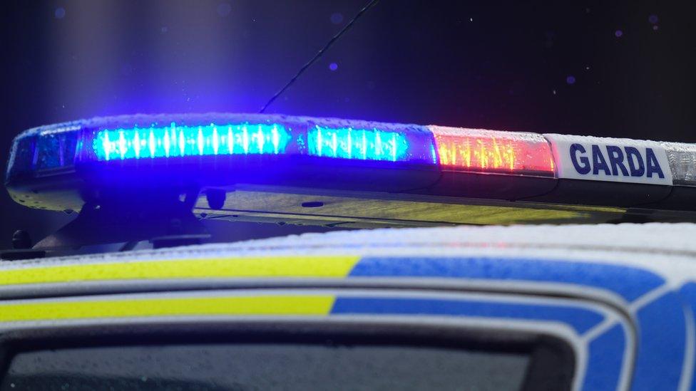 Flashing blue lights on top of a Garda car