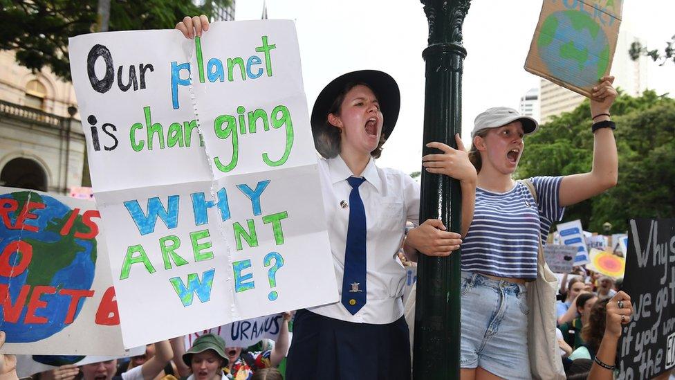 Student in Australia holds a banner during the protests.