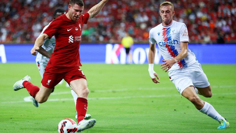 Liverpool controls the ball against Killian Phillips of Crystal Palace during the first half of their preseason friendly at the National Stadium on July 15, 2022 in Singapore.