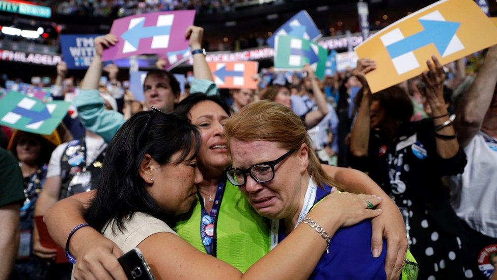 Carrie Pugh, left, Katrina Mendiola and Mayors Wegmann cry as Hillary Clinton officially becomes the first woman to be the presidential nominee