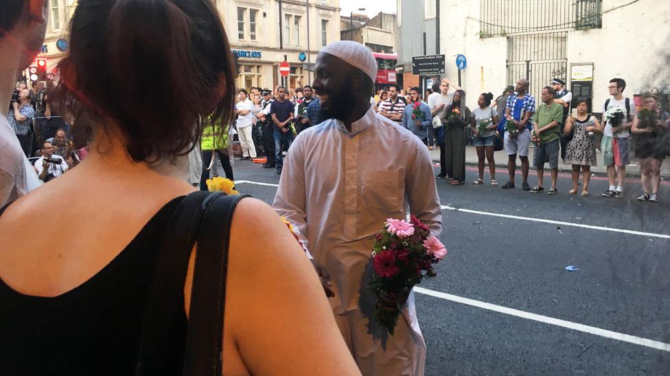 Muslim man receiving flowers