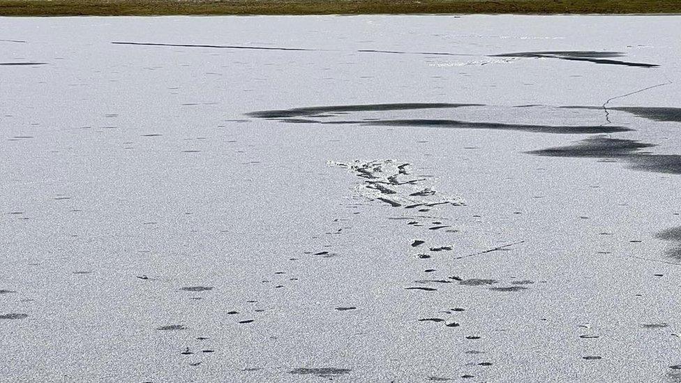 Footprints on frozen lake