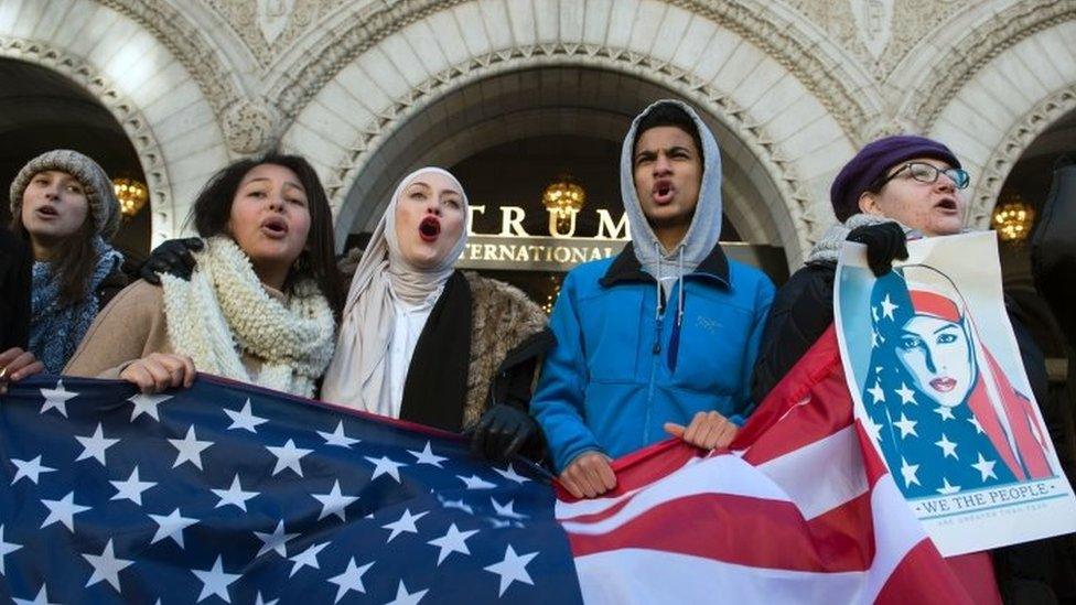 Protesters hold an US Flag while protesting outside the Trump Hotel in Washington DC. Photo: 4 February 2017