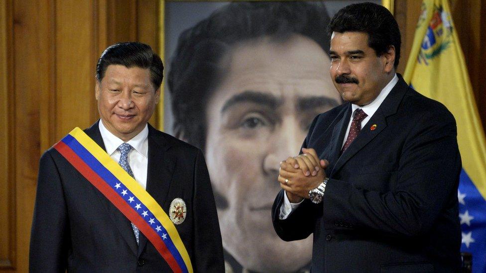 Venezuelan President Nicolas Maduro and China's President Xi Jinping , wearing a Venezuelan sash