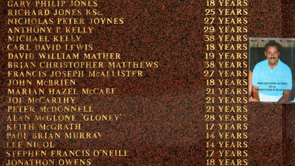 A photograph of Hillsborough victim Brian Christopher Matthews is attached to the Hillsborough memorial outside Anfield