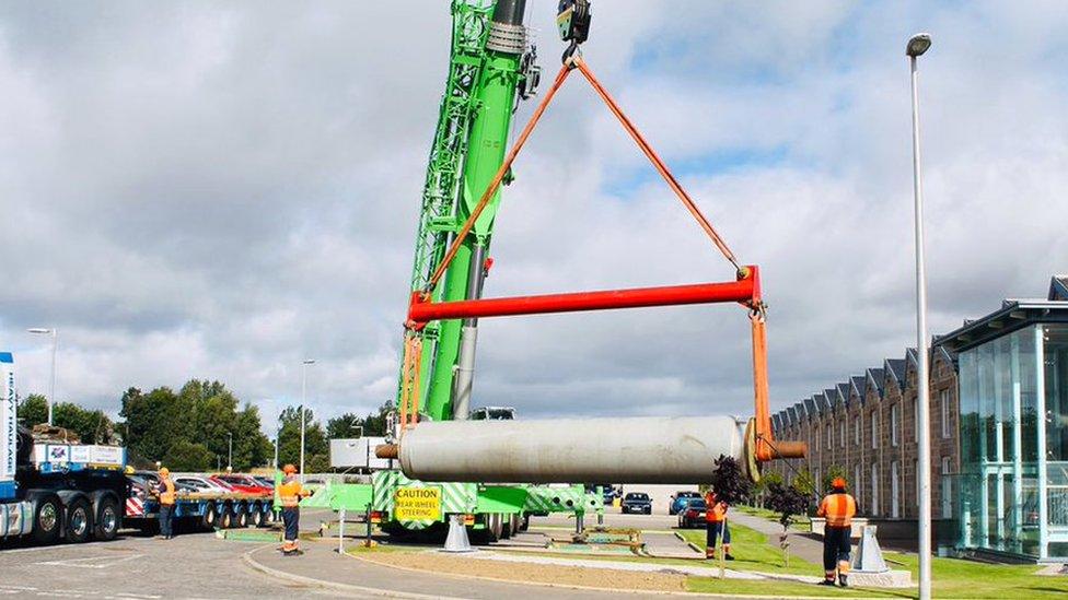 Granite roll being lifted into position