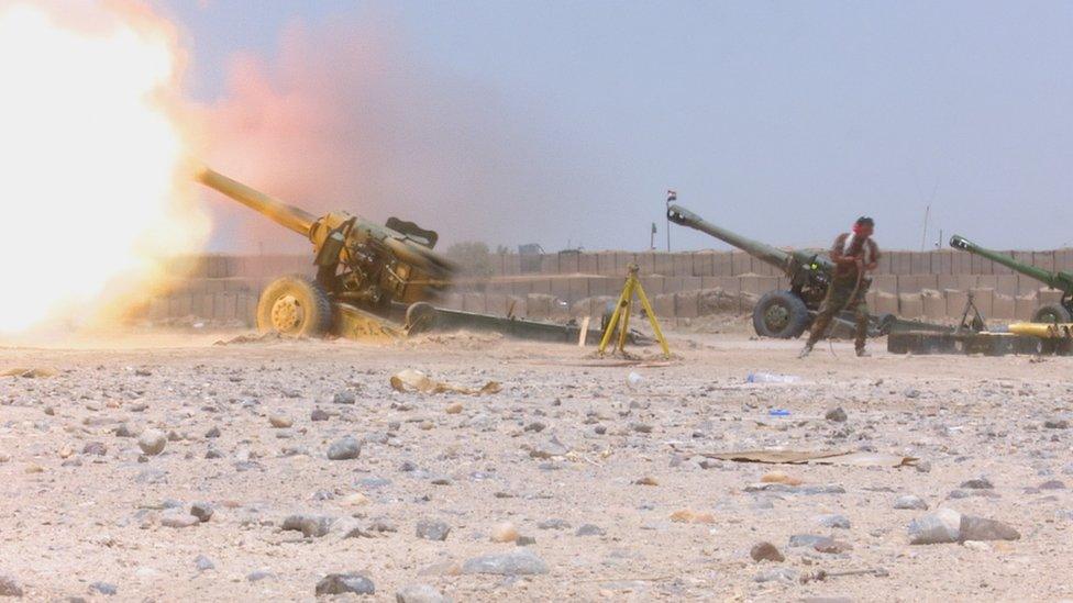 Shia militia fire artillery outside the Iraqi city of Falluja