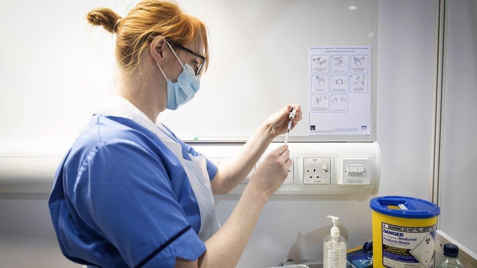 A nurse prepares a coronavirus vaccine