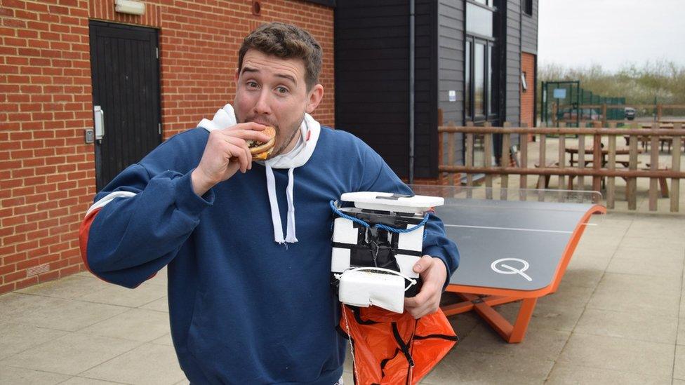 Image of Tom eating burger taken from Colchester United's Twitter page