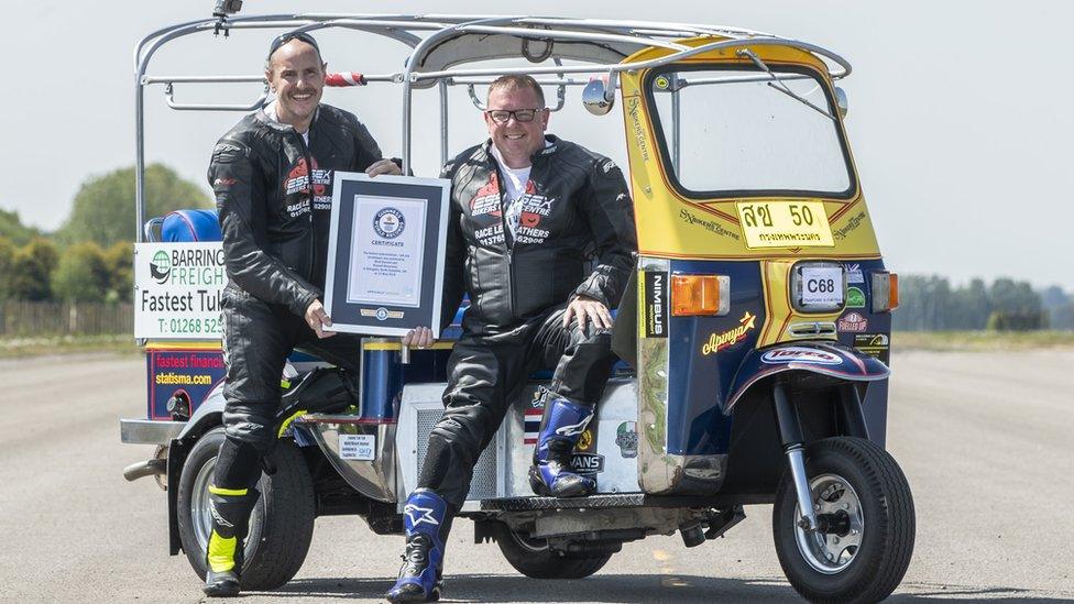 Matt Everard and Russell Shearman celebrate with their Guinness World Record after setting the world land speed record in their tuk tuk at Elvington Airfield.