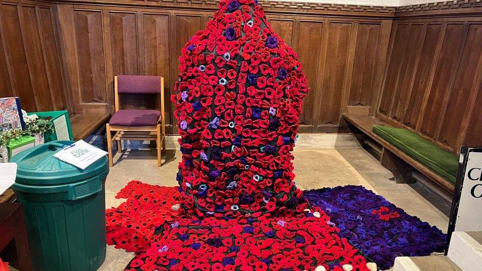 Large tribute made from red and purple poppies