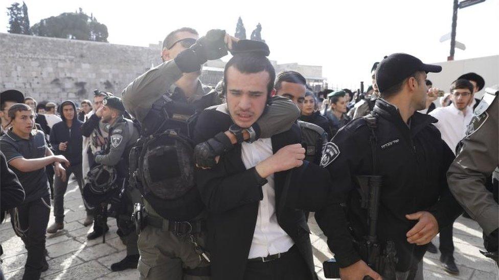 Israeli border police scuffle with ultra-Orthodox Jews protesting against members of the "Women of the Wall" feminist organization gathering inside the women's section of the Western Wall in Jerusalem's Old City, 8 March 2019