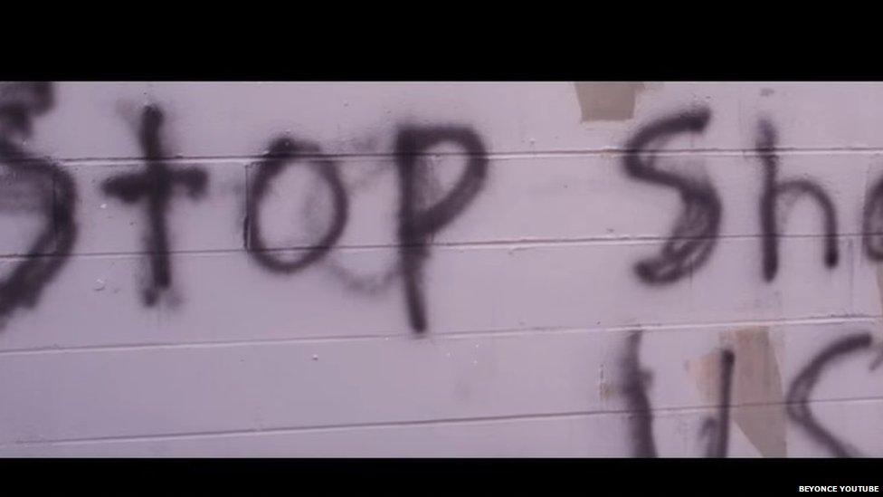 Graffiti which reads Stop Shooting Us