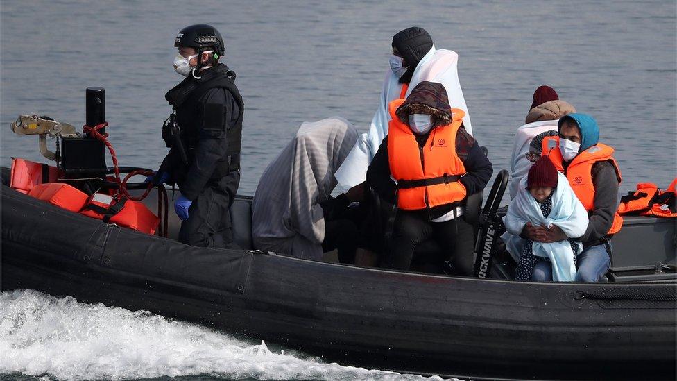 A group of people thought to be migrants are brought in to Dover, Kent, by Border Force officers following a small boat incident in the Channel