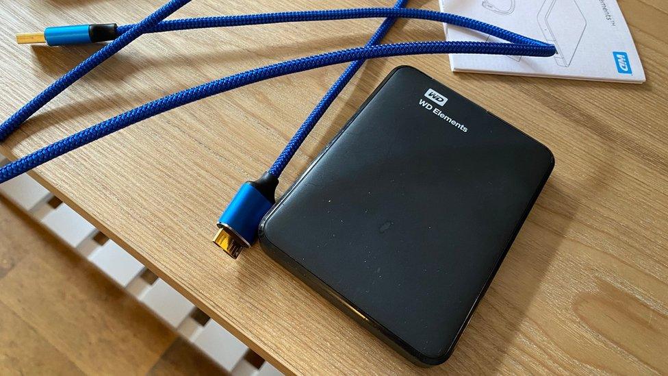 A Western Digital external hard drive and a gold-plated USB cable