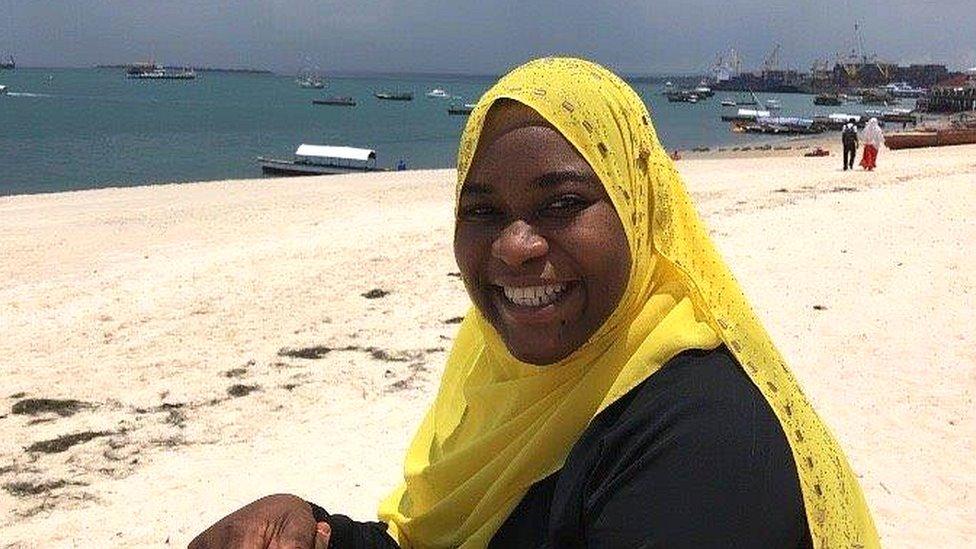 Khadija Abdulla Ali sitting on beach