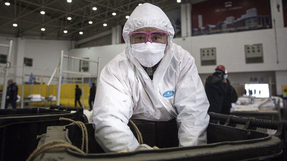 A worker wears a protective mask while cleaning construction waste at WuhanKeting on February 4th.2020 in Wuhan.Hubei Province,China.