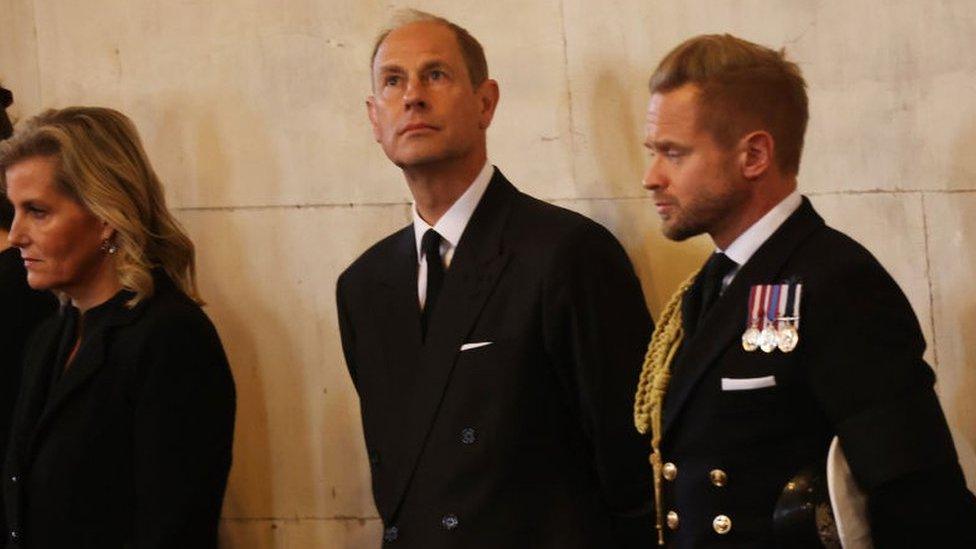 Earl and Countess of Wessex, in black, looking at the ceremony.