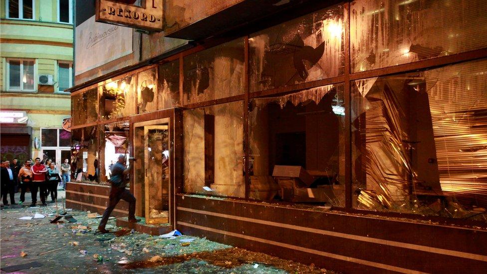 A police officer enters the President’s office demolished by protestors in downtown Skopje, Macedonia, late Wednesday, April 13, 2016.