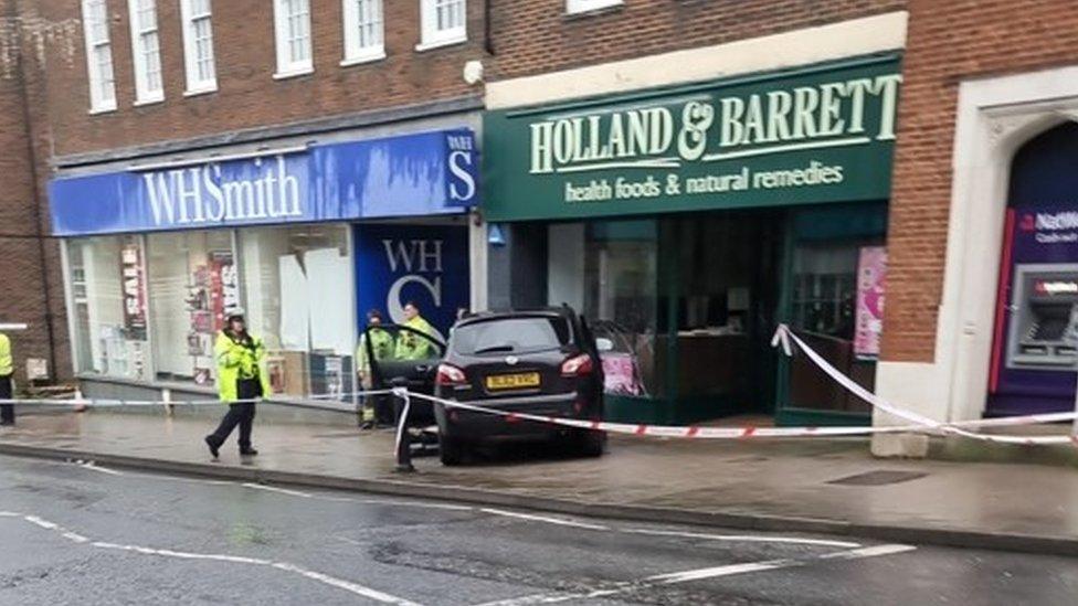 The car crashed into the store front