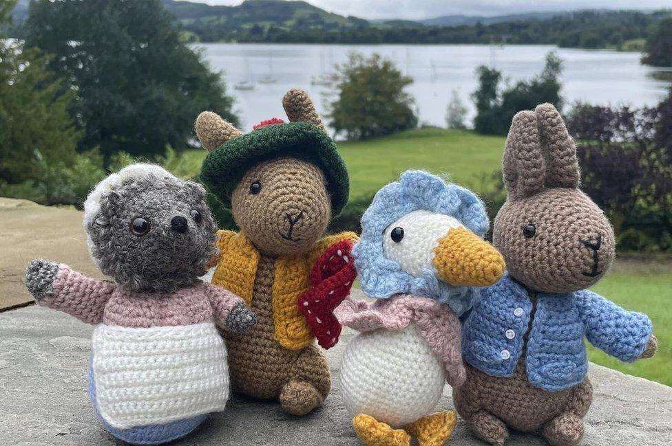 Four crochet figures on a bench