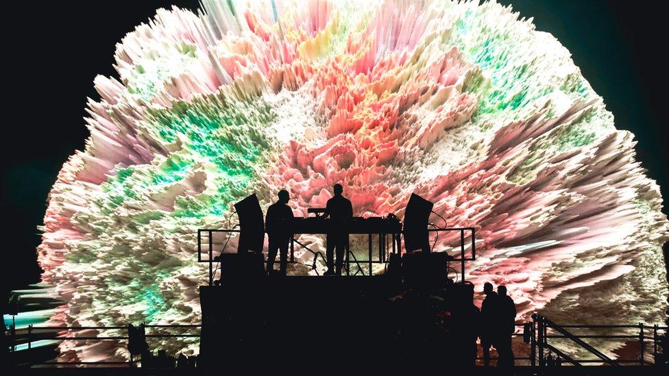 DJ playing at Creamfields North in front of a big screen