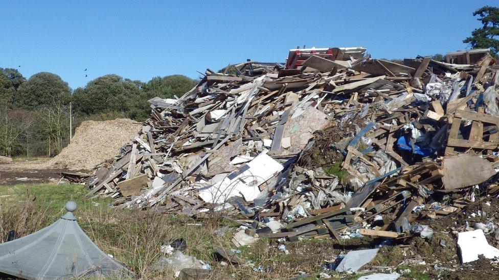 A big pile of waste wood and other waste at the site in Pyrton