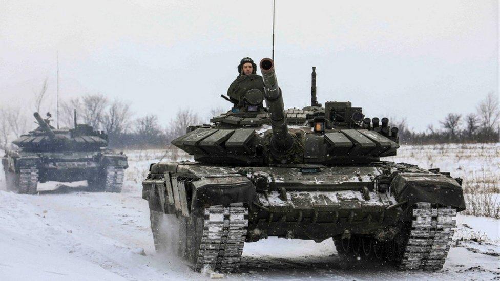 Russian servicemen drive tanks during military exercises in the Leningrad Region, Russia, on 14 February 2022.