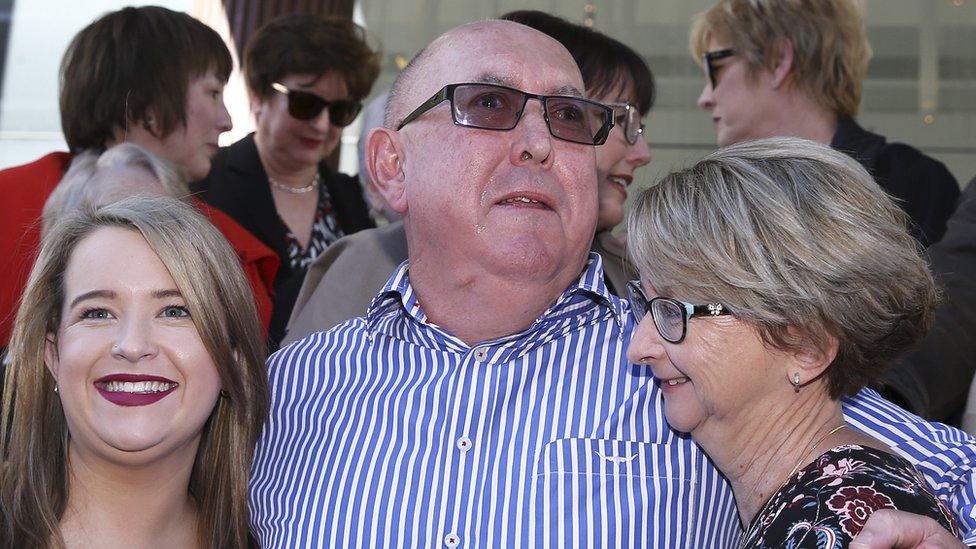 Peter Creigh hugging two female family members outside court