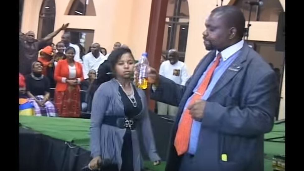 A man holds the bottle with petrol