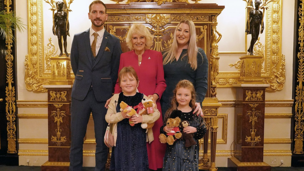 Queen Camilla with Olivia Taylor (front left) from south-east London next to her sister Imogen, father Matt and mother Lisa at Windsor Castle