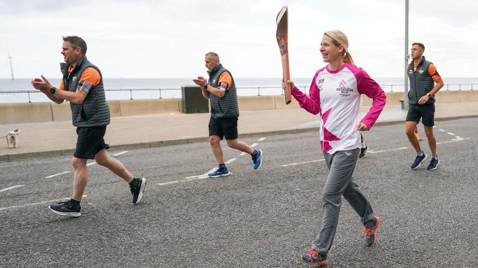 Johana Atkinson carries the Queen's baton at Redcar