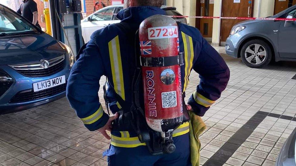 Ronnie Sherratt with a red cylinder on his back