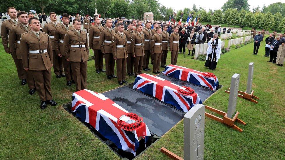 The coffins of two young privates and an unknown soldier, who fought during World War One, during a burial service at Hermies Hill British Cemetery near Albert, France.