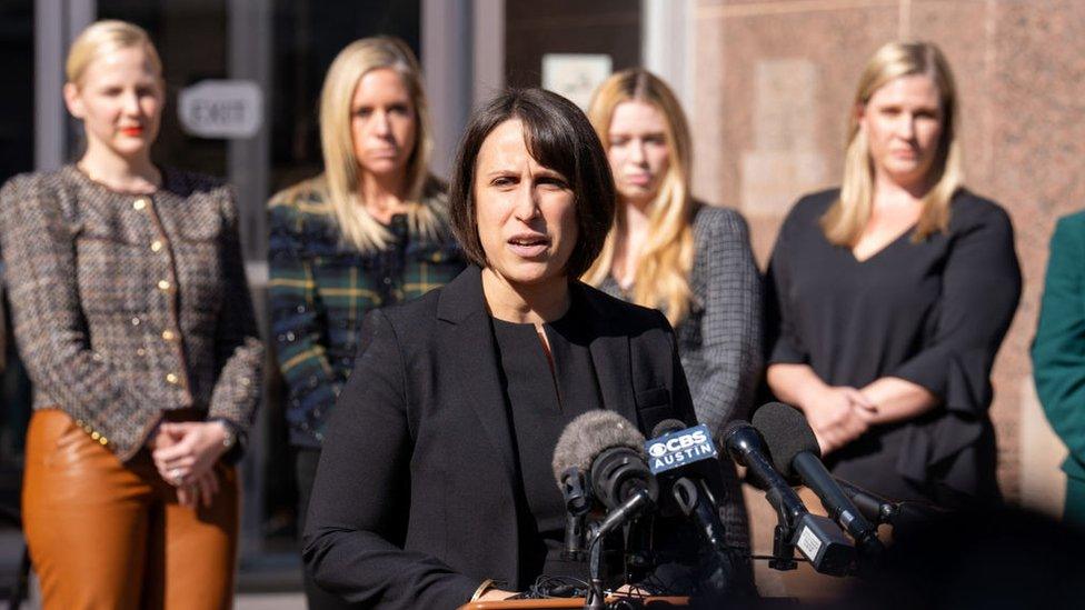 Molly Duane speaks from behind a podium