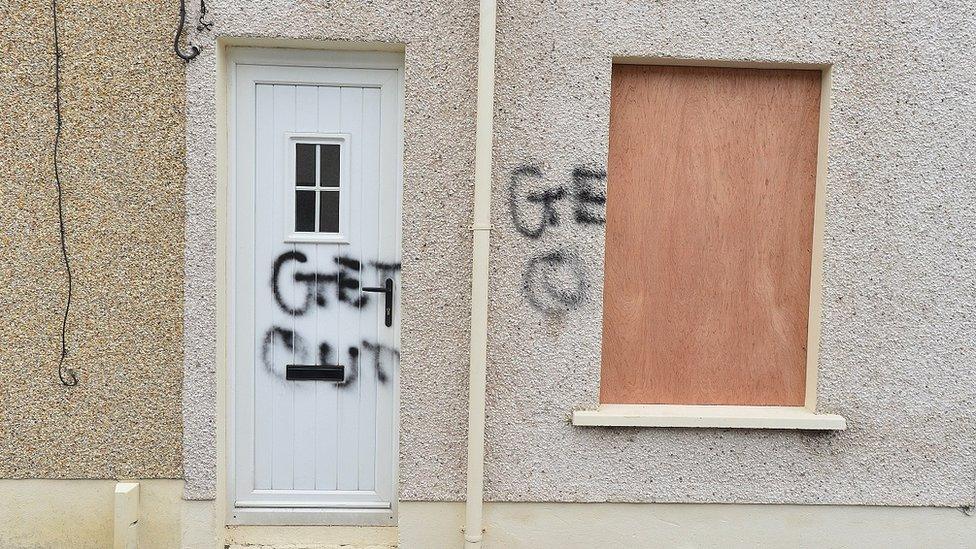 Paint saying Get Out daubed on door in Larne