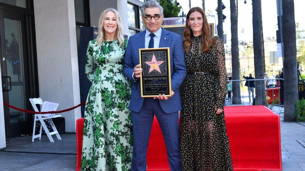 Canadian actor and comedian Eugene Levy (C) poses with his daughter Canadian actress Sarah Levy (R) and Canadian-US actress Catherine O'Hara during his Hollywood Walk of Fame ceremony in Los Angeles