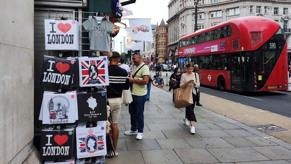 Tourist stall selling Queen memorabilia on Oxford Street